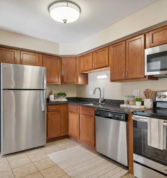 A kitchen with wooden cabinets and stainless steel appliances.