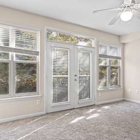 A room with a black chair and a grey cabinet.