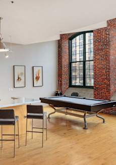 an open living room with a pool table and a bar