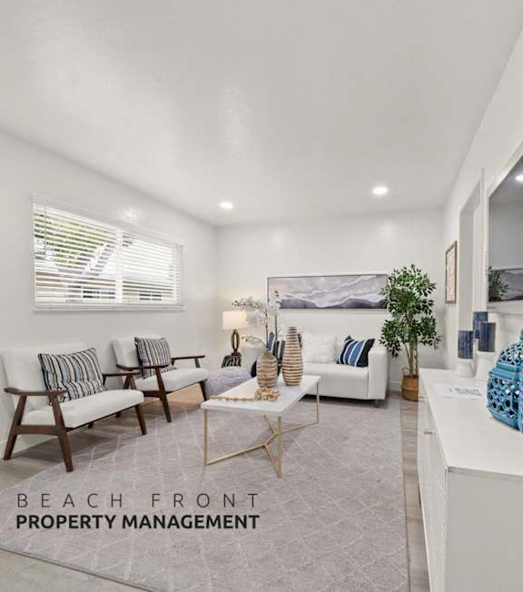 A well-lit, modern kitchen and living room with a dining area.