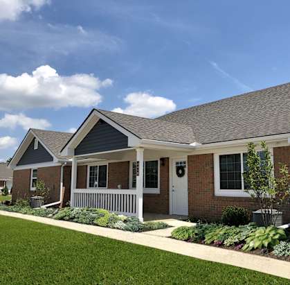 A row of houses with a well-maintained lawn in front.