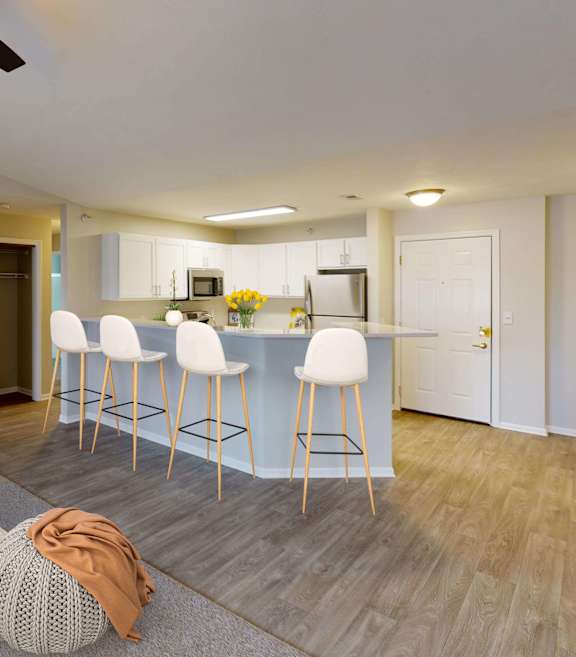 A modern dining room with a long table and chairs.