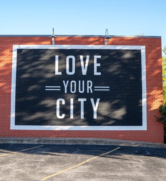 a mural on the side of a building that says love your city
