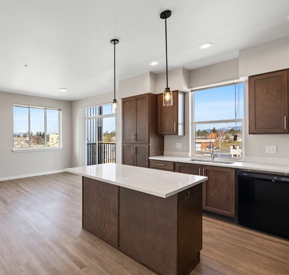 an open kitchen and living room with a large island