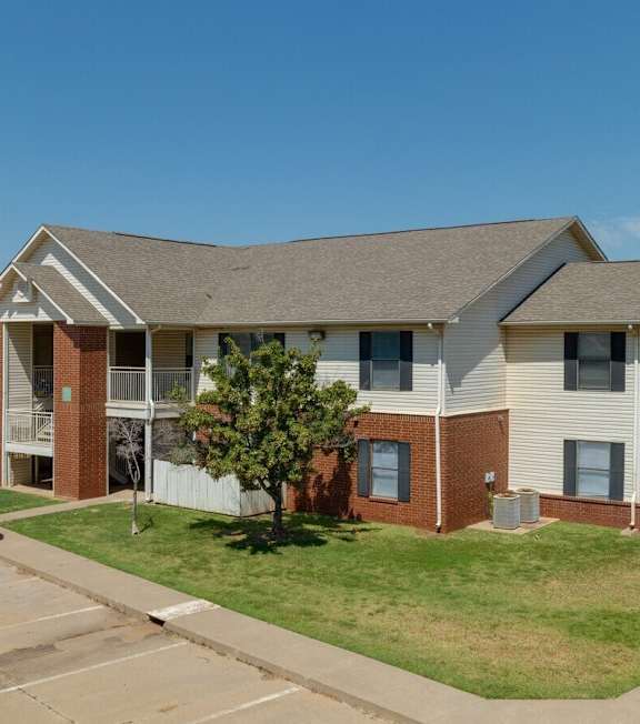 an apartment building with a truck parked in front of it at Chapel Ridge of Stillwater, Stillwater, OK, 74075
