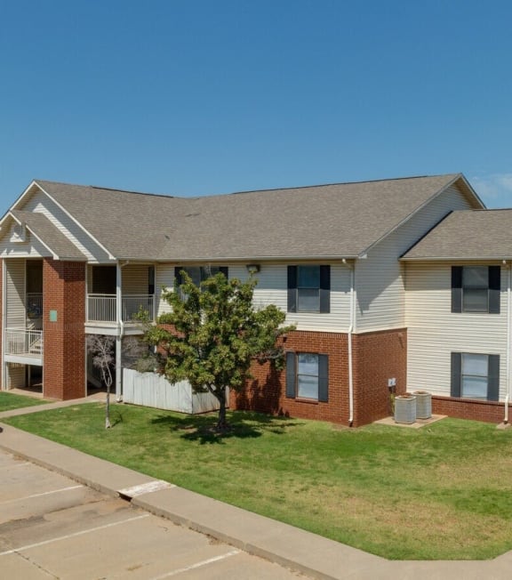 an apartment building with a truck parked in front of it at Chapel Ridge of Stillwater I & II, Stillwater, OK, 74075