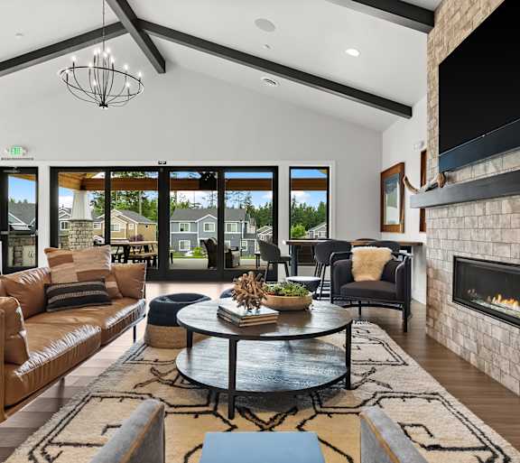 A modern living room with a fireplace and a large window.