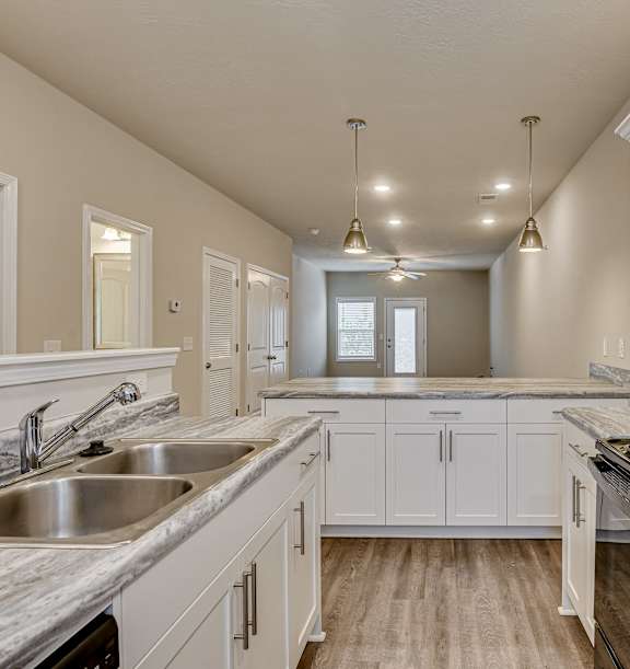 an open kitchen and dining area with a marble counter top at Barrington Apartments, Greenwood, SC