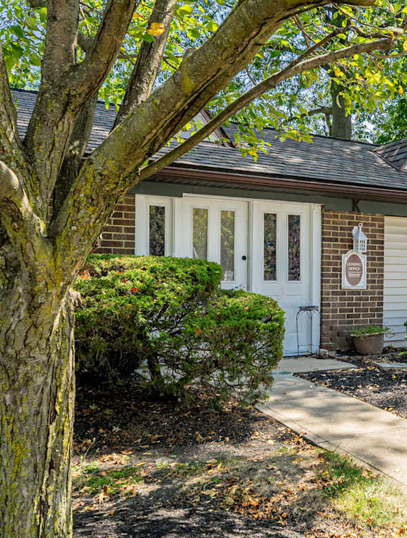 A house with a tree in front of it.