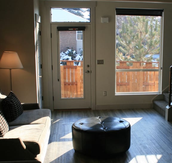 a living room with a couch and chairs and a staircase at Blue Koi by Lotus in Sugarhouse, Salt Lake City, UT