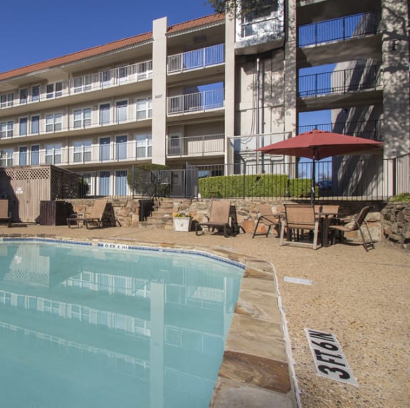 a swimming pool in front of a hotel  at Princeton Court, Dallas, TX, 75231