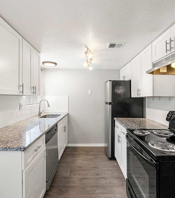 our apartments offer a living room with a couch and a tv at Northgate Townhomes in Tucker, GA, 30084