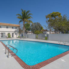 a swimming pool at a resort with a building in the background at Ocean Villas, Oxnard California