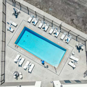 arial view of the pool and lounge area of a building with a swimming pool
