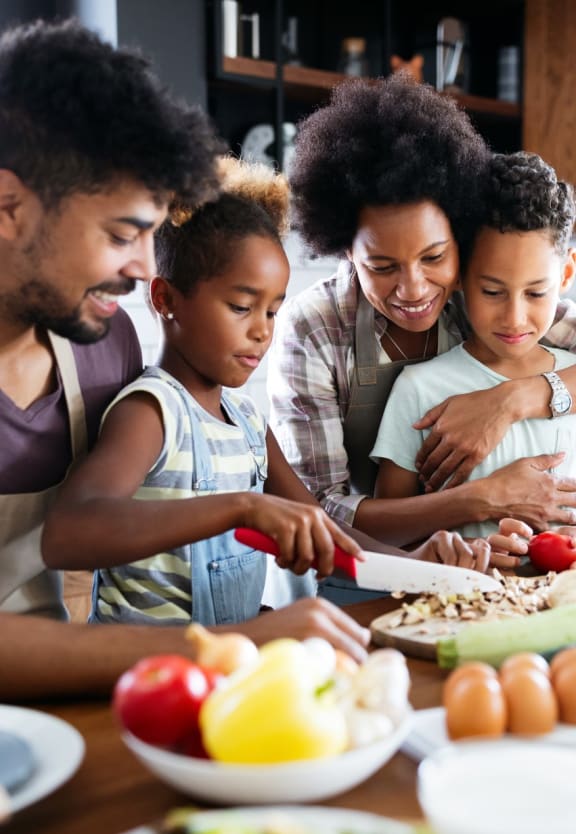 Family of Four in Kitchen Making Food