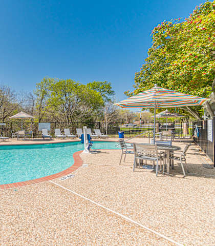 our apartments have a resort style pool with chairs and umbrellas