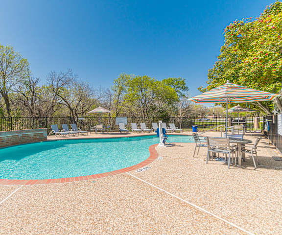 our apartments have a resort style pool with chairs and umbrellas
