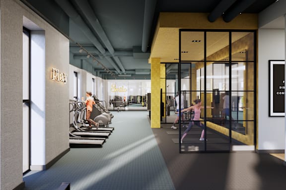 A modern gym with treadmills and exercise bikes.