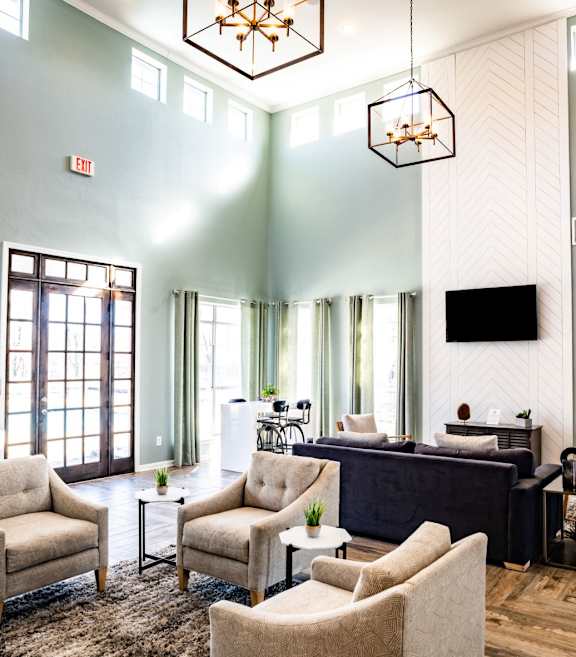 A kitchen with a black refrigerator, white cabinets, and a granite countertop. at Lincoln at Wolfchase Apartments, Tennessee