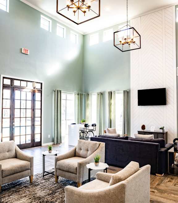 A kitchen with a black refrigerator, white cabinets, and a granite countertop. at Lincoln at Wolfchase Apartments, Tennessee