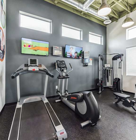 the gym is equipped with cardio equipment and televisions