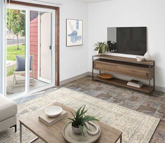 a living room with white walls and a sliding glass door