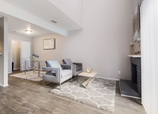 a living room with gray couches and a coffee table