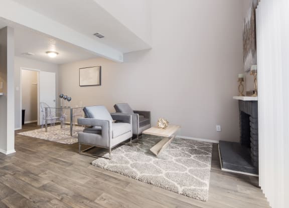 a living room with gray couches and a coffee table