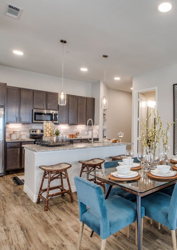 Open concept kitchen and dining area in an apartment at Berkshire Exchange, Spring TX 77388