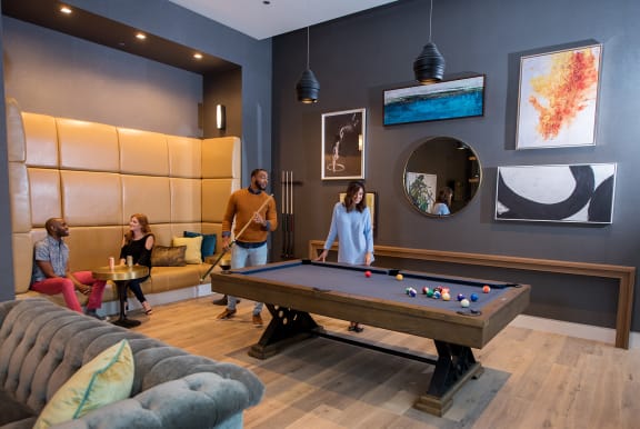 Residents Playing Billiards at The Apartments at Lincoln Common in Chicago IL