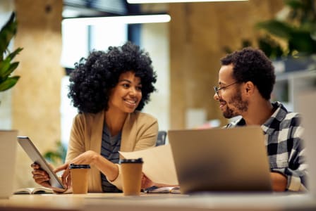 Lifestyle photo of two people working on laptops
