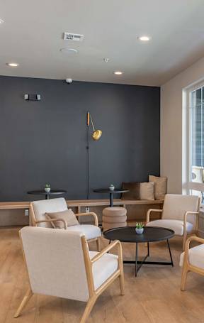 A living room with a black wall and white chairs at Westgate Apartment Homes, Pendleton, OR, 97801