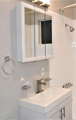 a white bathroom with a sink and a bath tub at Trailhead Apartments at Tam Junction, Mill Valley, CA