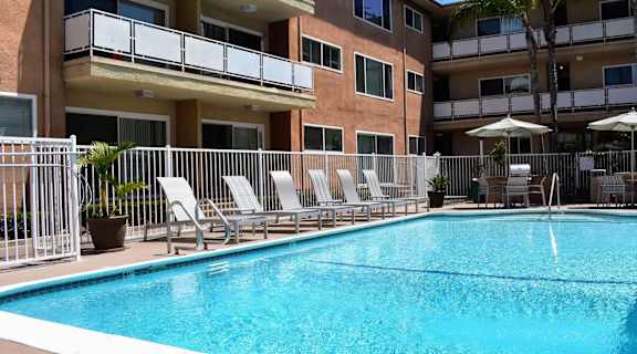 community pool and lounge chairs