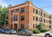 Thumbnail 29 of 67 - a brick building on the corner of a city street