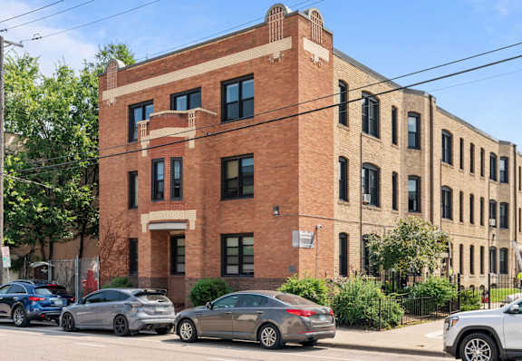 a brick building on the corner of a city street