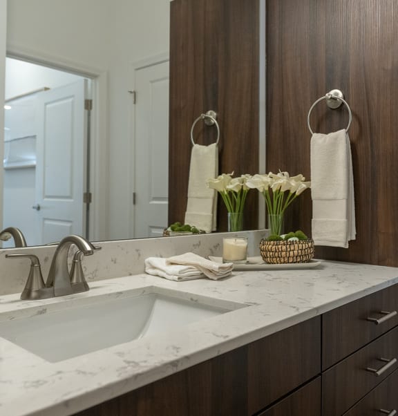 a bathroom with a sink and a mirror  at The Clearing at ONE28, Olathe, 66062