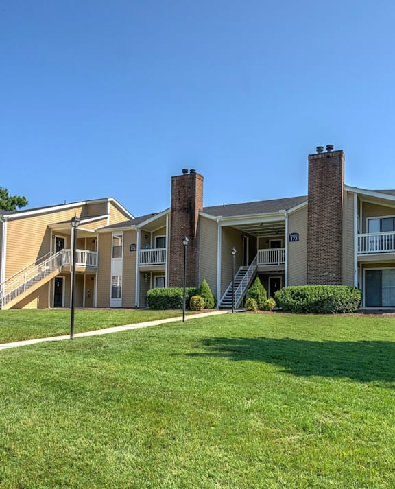 Apartment building with a blue and beige exterior. at Fox Hollow Apartment Homes, High Point, NC, 27265