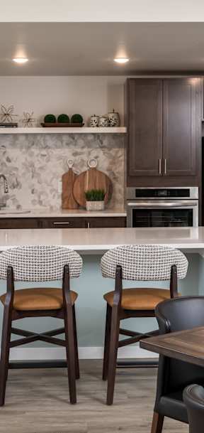 A kitchen with a bar area and a dining table.