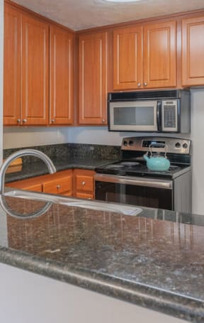 a kitchen with a granite counter top and at City View Apartments at Warner Center, California