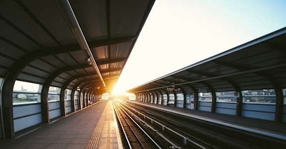 A train station with a train track leading into the distance.