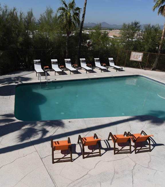 A large swimming pool in front of a resort.