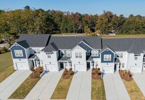 A row of houses with a road in front.