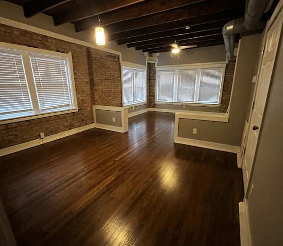 the view from the top of a staircase looking down into a room with a window