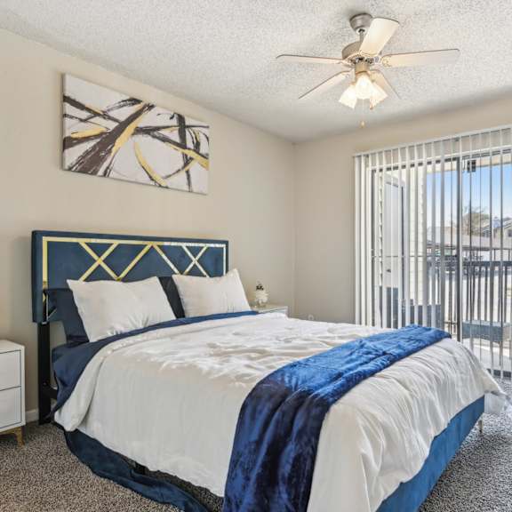 A spacious room with a fireplace, couches, and a ceiling fan.