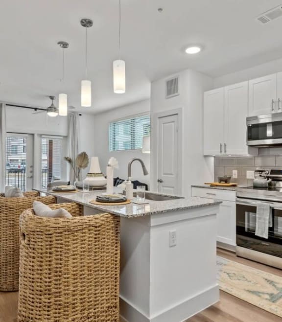 an open kitchen and living room with a table and chairs