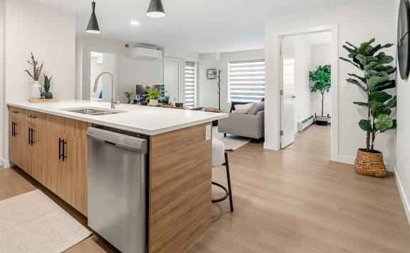 a kitchen with an island and a living room with a couch