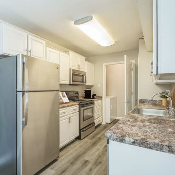 a kitchen with stainless steel appliances and granite counter tops