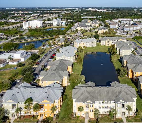 A large apartment complex with a lake in the middle.