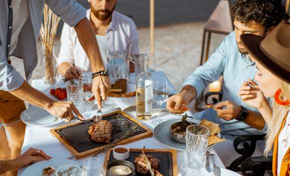 a group of people eating food at a table at The Standard, South Carolina
